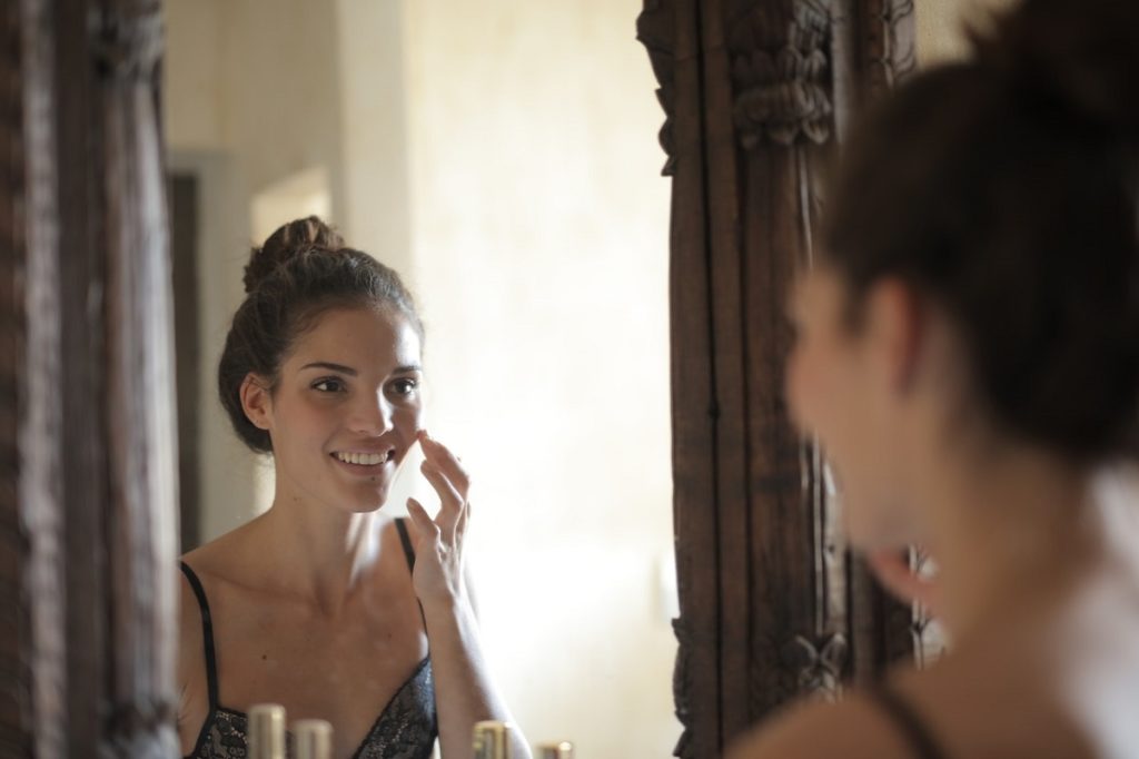 Woman looking at herself in the mirror